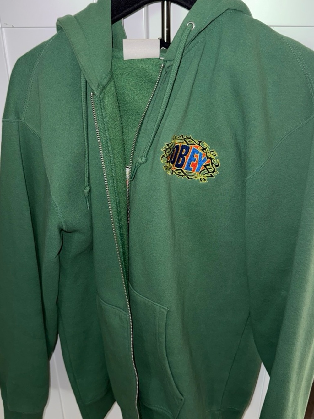 Green zip-up hoodie with logo